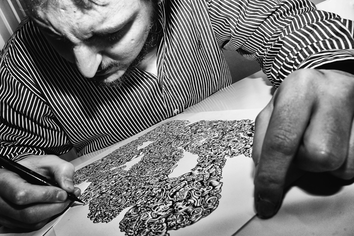 Deep in concentration, Boyane puts a finishing touch on one of his drawing.