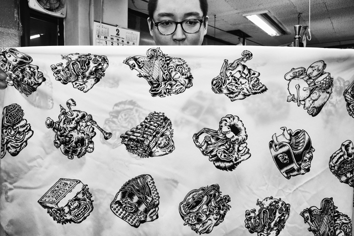 Soung Young Moon examines the customized fabric depicting Boyane’s artwork in his office at the B&B Pattern Research Center.