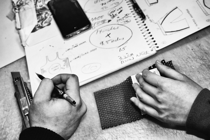 Soung Young and Rydia look over notes and materials that will be used to create their new line of tank tops. 