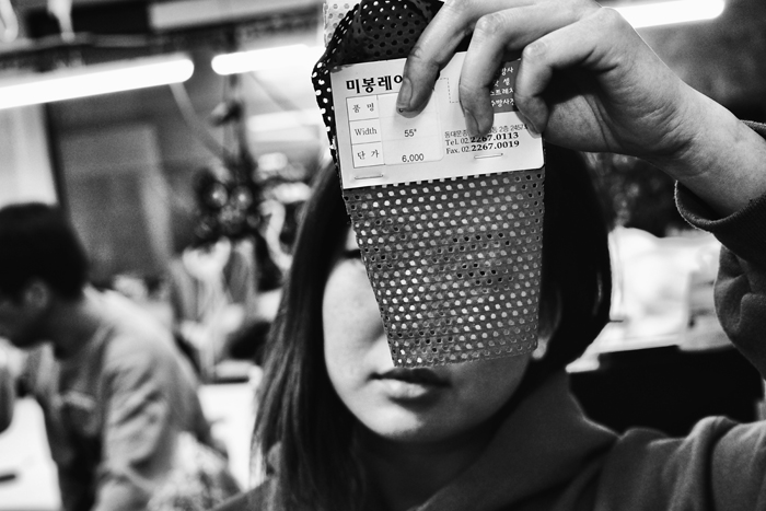 With the inherent qualities of a particular fabric in mind, Rydia looks through a sample swatch. 