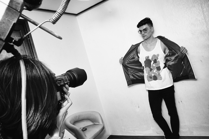 Model Troy Brouillette shows off a new Varyd tank top as House captures another photograph for the catalog.