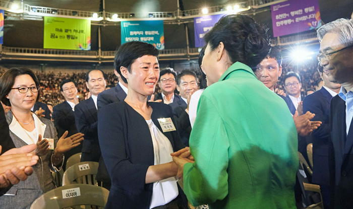 President Park Geun-hye passes along words of encouragement to a North Korean defector who recently married in Korea during the 17th National Unification Advisory Council on July 1.