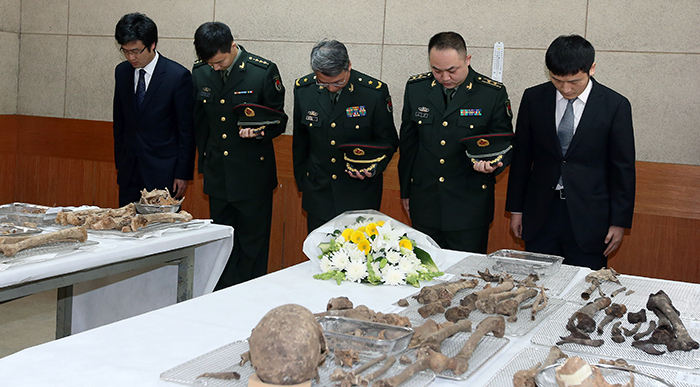 Chinese military officials lay wreaths and pay their respects to the remains of Chinese soldiers who were killed during the Korean War, during a coffin rites ceremony on March 16.