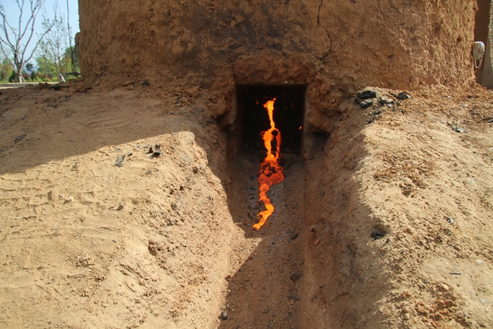 Molten steel trickles downward during the reenactment of ancient steel-making techniques held on May 27.