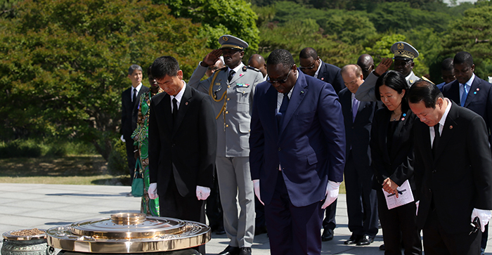 President of Senegal Macky Sall pays silent tribute at the Memorial Tower at the Seoul National Cemetery on June 4.