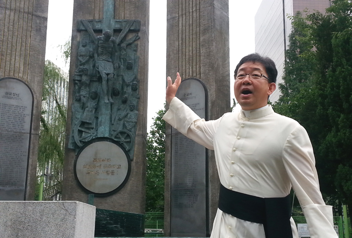 Father Joseph Lee Joon-seong of the Yakhyun Catholic Church stands in front of the 15 meter Hyunyang Tower, dedicated to Catholic martyrs, at the Seosomun Martyrs’ Shrine in central Seoul. 