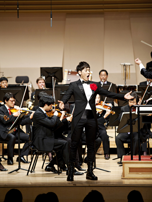 Actor and singer Kai sings on stage. 