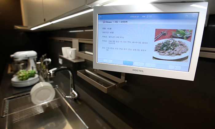 A touch-screen monitor in the kitchen shows a recipe.