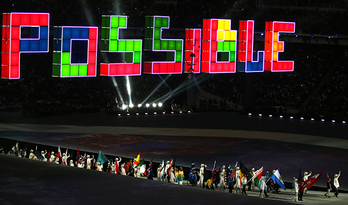 Flag bearers representing their countries march beneath the word ”Possible” during the Sochi 2014 Paralympics closing ceremony. (photo: Yonhap News)