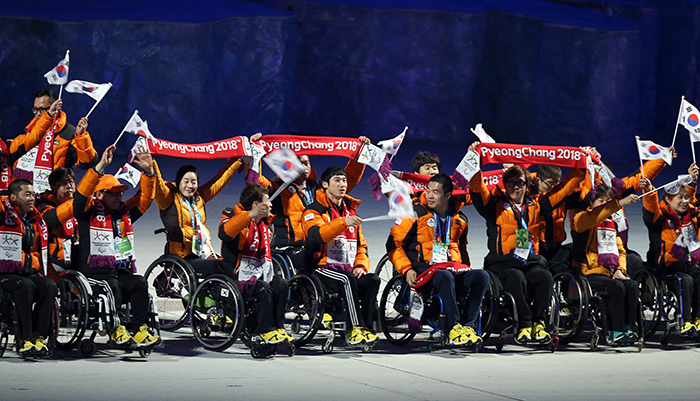 Team Korea waves the national flag, the Taegeukgi, and PyeongChang 2018 banners while entering the stadium for the Sochi 2014 Paralympics closing ceremony on March 16. (photo: Yonhap News)