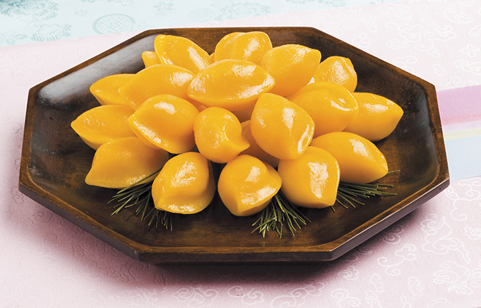 <i>Hobak songpyeon</i> is made with pumpkin. Pieces of dried pumpkin harvested from the previous winter are used to make a pumpkin powder which is added to the rice powder to make the dough.