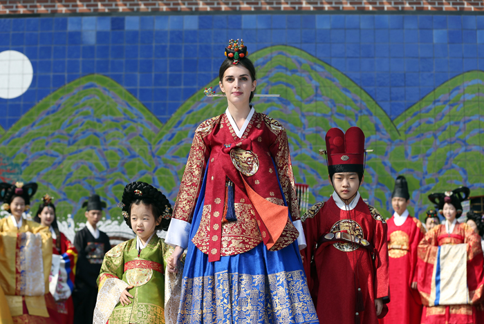 Capucine Fabert, the only non-Korean model in the parade, and two children, all dressed in royal hanbok, walk the catwalk during a fashion show at the “Spring of Insadong” hanbok festival on March 22. (photo: Jeon Han)