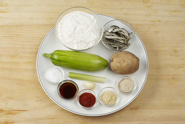 The ingredients for <i>sujebi</i> include flour, anchovies, zucchini, potato, green onion, salt, garlic and various seasonings.