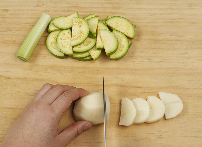 Wash, trim and halve the zucchini and potato. Cut each into bite-sized pieces. If the zucchini is too thick, cut it into quarters.
