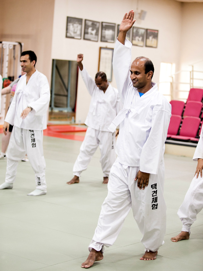 A group of <i>taekkyeon</i> practitioners from 25 countries study the traditional martial art on August 30. 