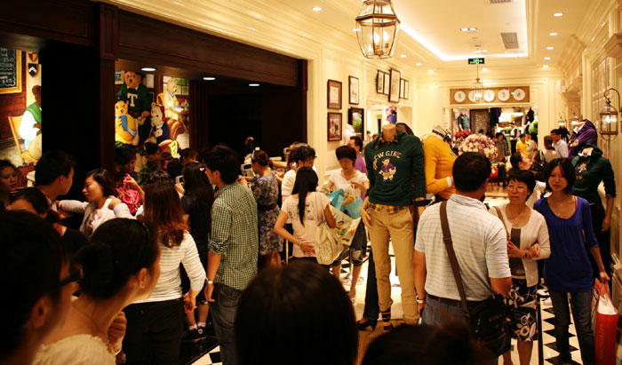 A Teenie Weenie shop is crowded with customers in China. Many of the visitors love to take photos with the iconic teddy bears.