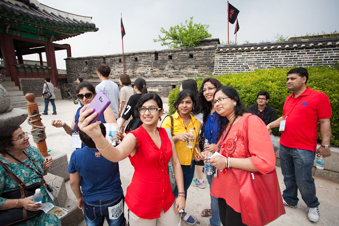 Participants take pictures against the backdrop of the Hwaseong Fortress in Suwon, Gyeonggi-do. 