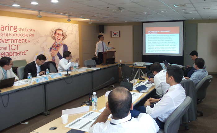Uzbek government officials listen to lectures on online government services and ICT policies.