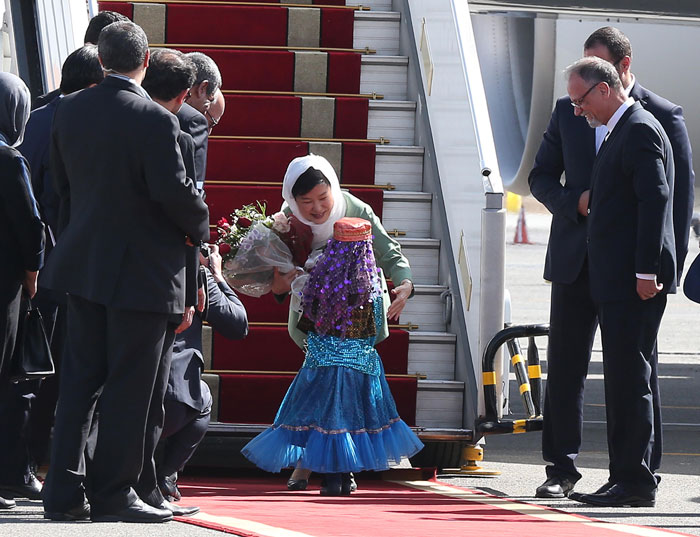 President Park Geun-hye hugs an unidentified Iranian girl after receiving flowers from her at Tehran Mehrabad International Airport on May 1.