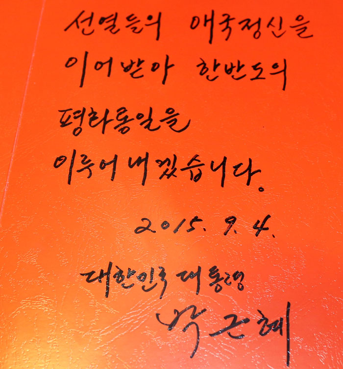 President Park Geun-hye writes, “I will surely make a peaceful unification come true by fulfilling the spirit of the patriotic martyrs,” in the guestbook during her visit to the building of the Provisional Government of the Republic of Korea in Shanghai.