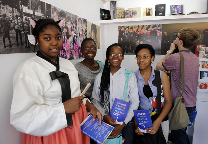 Visitors look around a pop music themed booth at the London Korean Festival 2015.