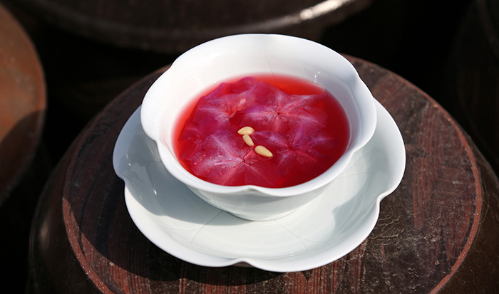 Azalea punch is decorated with petals and pine nuts.