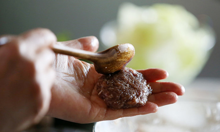 Shape the marinated ground beef into bite-sized meatballs. Roast the meat in a heated pan over medium heat.