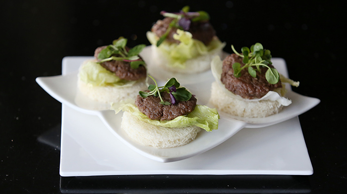 Modern bulgogi is a dish where one enjoys marinated beef with bread and fresh vegetables.