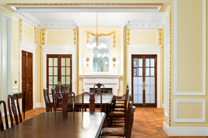(Top) The grand dining room on the first floor is shown in a picture taken in 1918. (Bottom) The grand dining room after restoration. 