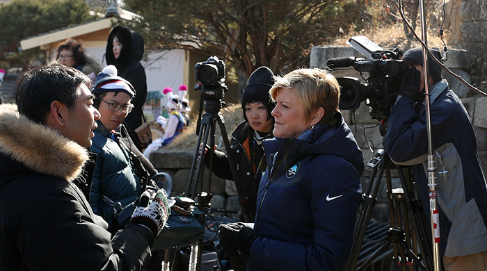 NBC interviews an organizer for the traditional group bow, in Gangneung on Feb. 17.