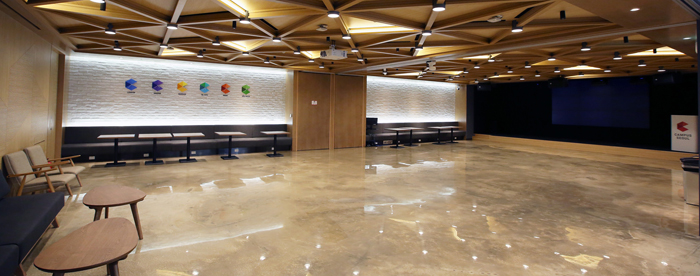 Lockers for employees (top) and a multipurpose room with a small stage (bottom) can be seen at Campus Seoul.