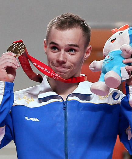 Ukrainian gymnast Oleg Verniaiev holds up his medal during the awards ceremony at the Gwangju Summer Universidae. Verniaiev won gold medals in the men's individual all-around and in the horizontal bar.
