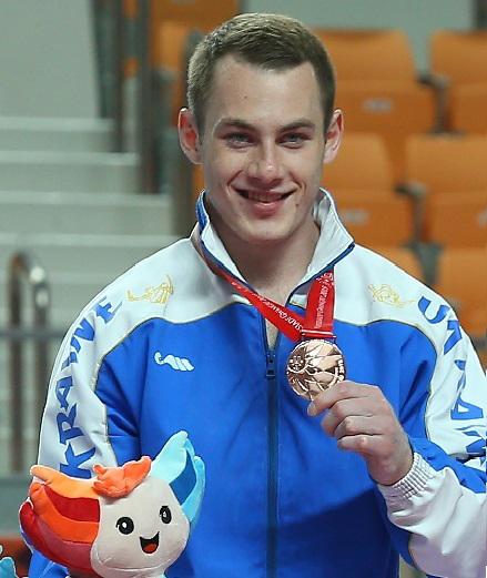 Igor Radivilov from Ukraine shows off his medal during the awards ceremony at the Gwangju Summer Universiade. He won silver medals in the vault and the rings.