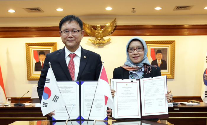 Vice Minister of Government Administration and Home Affairs Chung Chae-gun and Rini Widyantini, deputy of institutional affairs at Indonesia's Ministry of Administrative Reform andBureaucratic Reform, hold up the MOU where they agreed to establish and manage the Korea-Indonesia e-Government Cooperation Center in Jakarta, on Aug. 24.