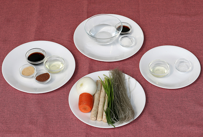 The main ingredients in simple <i>japchae</i> are glass noodles, unrefined sugar, brown sugar, soy sauce, carrots, onions and burdock.