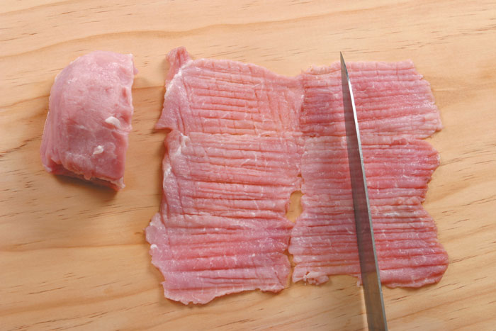 Make fines knife creases on both sides of the meat after cleaning off the blood. It needs to have the fine creases otherwise the meat will shrink.