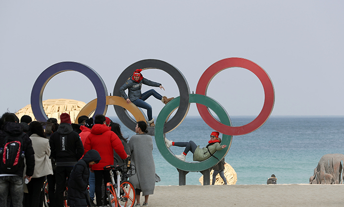 German athletes have fun taking photos with the Olympic rings at an outdoor square in front of Gyeongpo Beach in Gangwon-do Province on Feb. 22.
