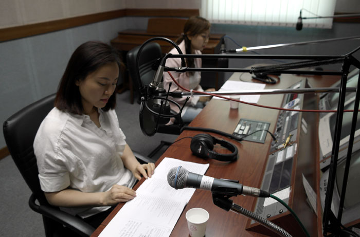 Volunteers record an educational radio broadcast at a local radio network aimed at multicultural families. (photo courtesy of the Incheon Metropolitan Election Commission)