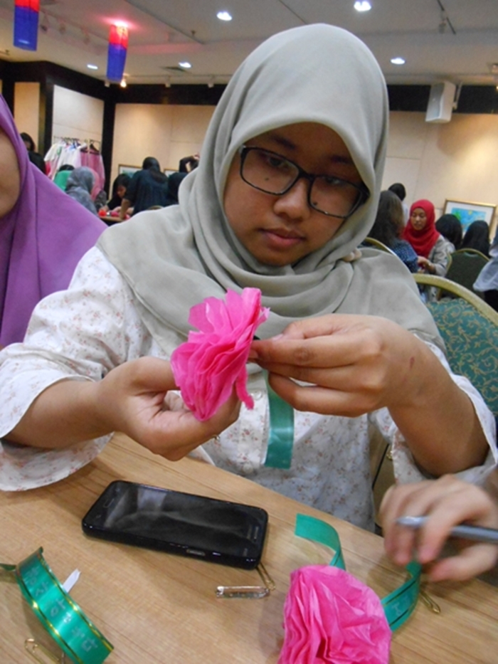 One of participant seriously making carnation