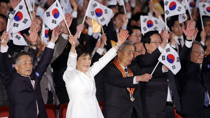 After making a Pledge of Allegiance to the nation, President Park Geun-hye (second from left) and other attendees call out in celebration during a ceremony to commemorate the March First Independence Movement, at the Sejong Center for the Performing Arts in Seoul on March 1. 