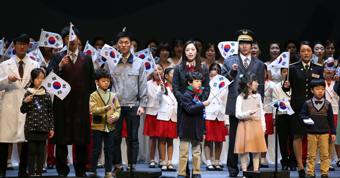 Members of a children's choir and descendants of Korea's independence movement activists wave Korean flags during a ceremony to commemorate the March First Independence Movement. 
