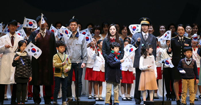 Members of a children's choir and descendants of Korea's independence movement activists wave Korean flags during a ceremony to commemorate the March First Independence Movement. 