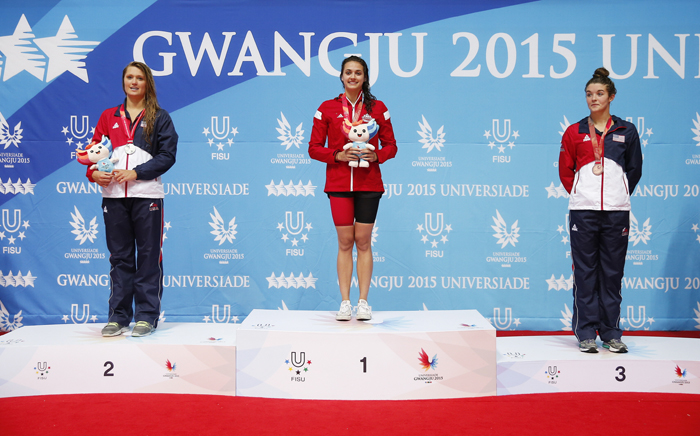 (From left) Elizabeth Peltonof the U.S. (silver), Kylie Jacqueline Masse of Canada (gold ) and Rachel Bootsma of the U.S. (bronze) stand on the podium during the awards ceremony after the women's 100-meter backstroke final on July 7.
