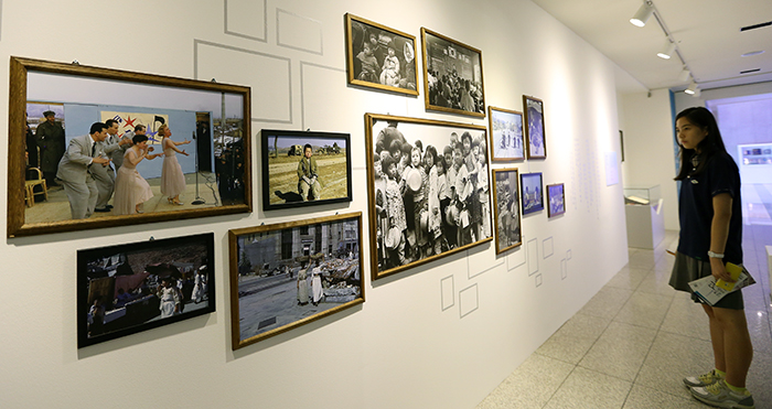 A visitor looks at photos from the 1950s at the special exhibit on the Korean War titled 'Flowers Blooming in the War' at the National Museum of Korean Contemporary History. 