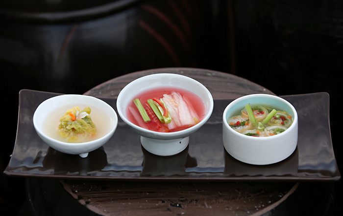 Triple white kimchi uses white kimchi, which is characterized for its light, clear and crunchy taste. It's called 'triple' because the dish prepares white kimchi three different ways: as a roll, as a pouch and as a salad.