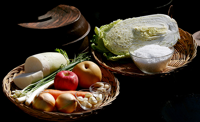 The main ingredients in triple white kimchi are cabbage, raddish, carrots, green onions, onion, ginger, garlic and salt.