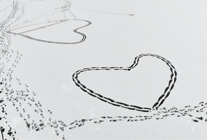 Footprints form heart in snow