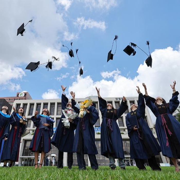 Graduating students throw caps into air