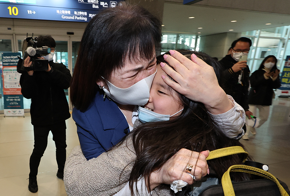 Anita Nam, 10, a Goryeoin (ethnic Korean from Central Asia) from Ukraine, on the morning of March 22 hugs her grandmother after arriving at Incheon International Airport's Terminal 1. 