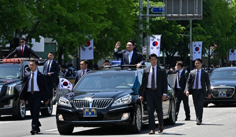 President Yoon Suk Yeol on May 10 waves to the crowd in a motorcade after his inauguration ceremony at the National Assembly in Seoul.  (Kang Min-seok from Presidential Security Service